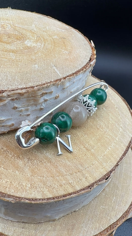 Broche réalisée sur mesure avec des perles de malachite et une perle souvenir avec des poils de chats